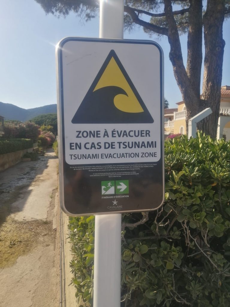 Tsunami evacuation sign on the beach under Azure Equilibrium